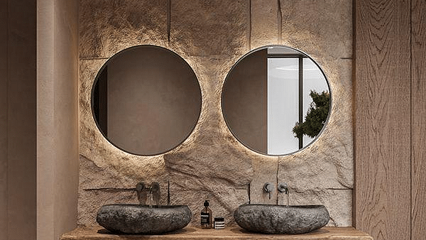 Hand wash area with two ash basins and two round wall-mounted mirrors above at The Evren, Vagator.