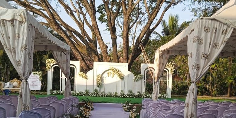 image of a wedding reception with a white pathway featuring in the middle at Hoysala Village Resort, Hassan