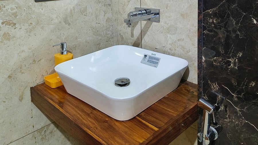 A sink with a mirror on the top of it in the washroom at 102 room at Ananda Holiday Home, Wayanad 2