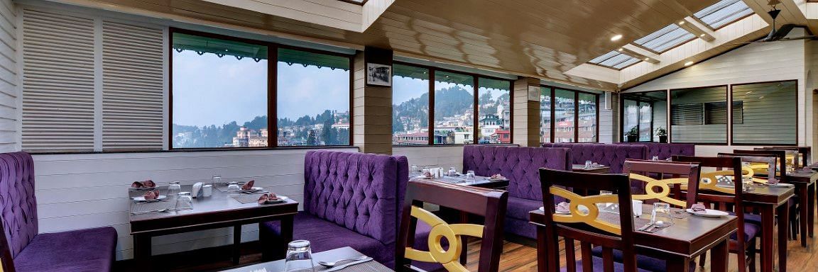 Restaurant Blue charcoal with sofas for seating as well as chairs with tables in the middle  - Sumitel Boutique Resort, Darjeeling