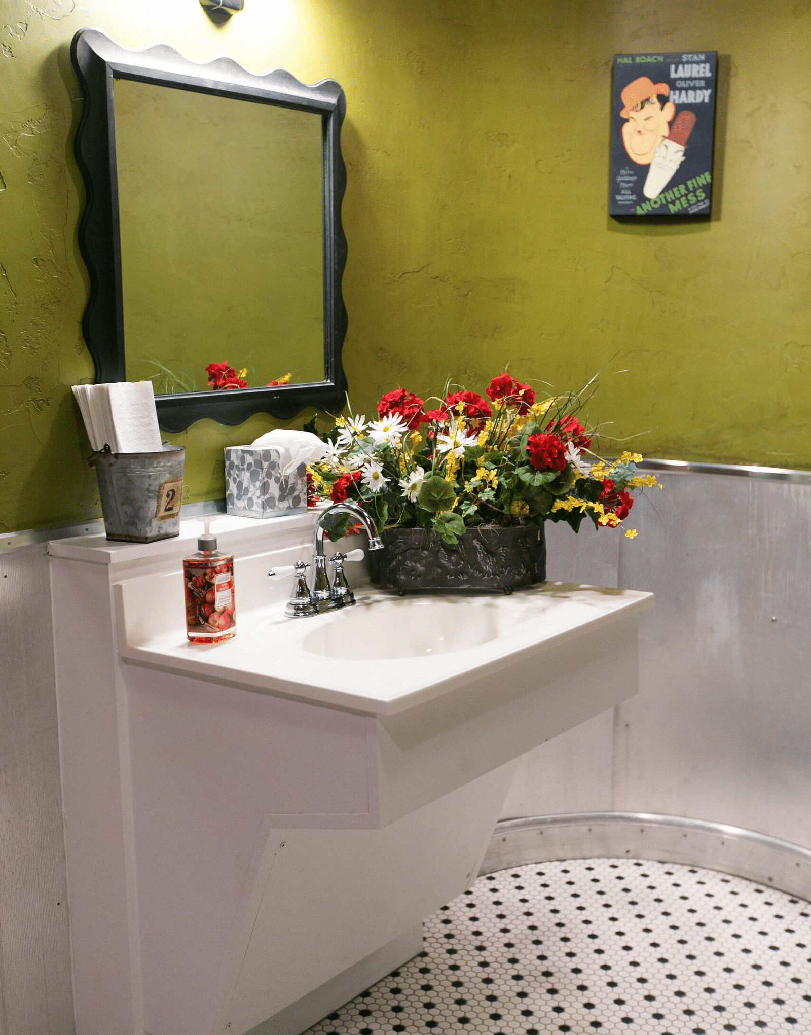 a wash basin with a flower pot kept beside it at the Tin Can Theater - Historic Tapoco Lodge