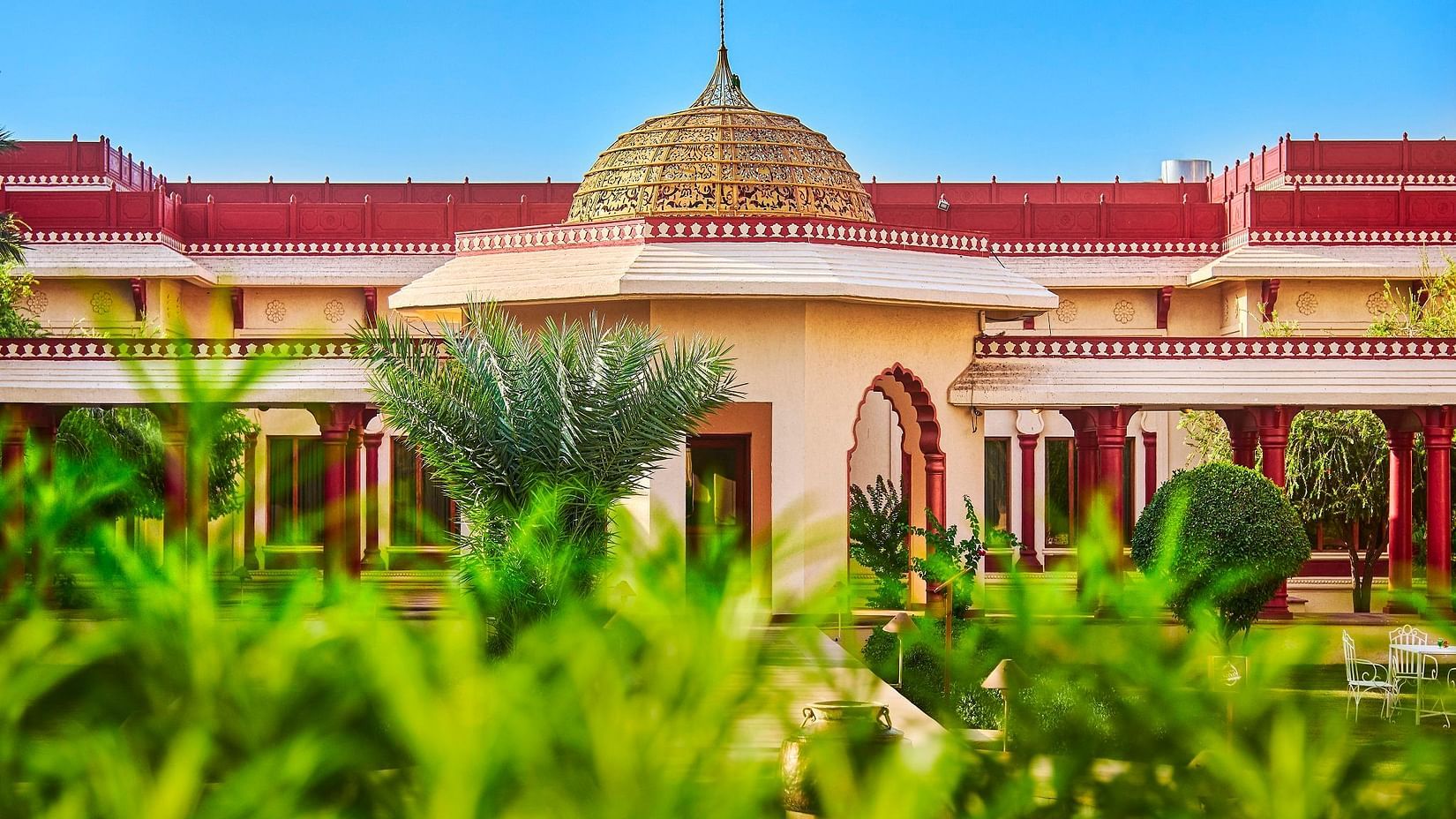 a closer view of our hotel surrounded by green trees - The Ummed Jodhpur, Palace Resort and Spa