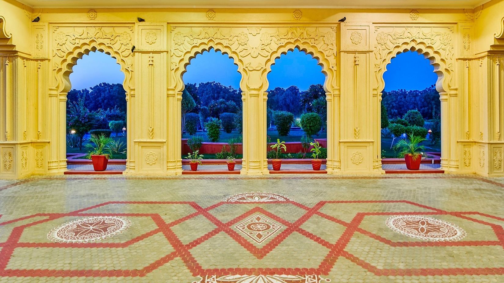 facade view of grand hotel with yellow pillars - The Ummed Jodhpur, Palace Resort and Spa