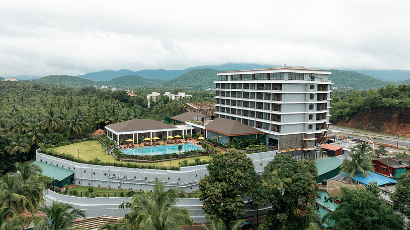 An aerial view of the facade of Cloud9 Sarovar Premiere, Palolem Goa, reveals lush trees surrounding the area, enhancing the serene and natural setting.