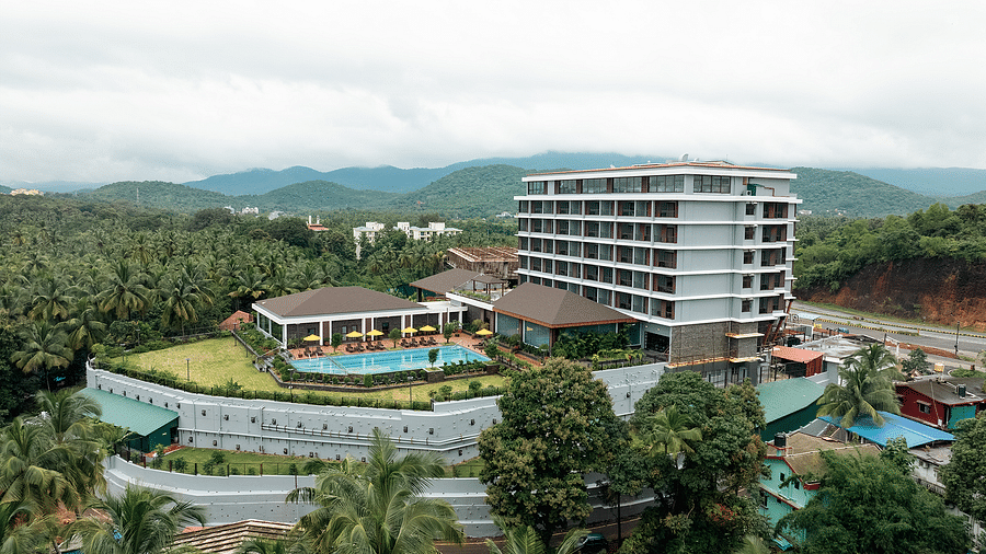 An aerial view of the facade of Cloud9 Sarovar Premiere, Palolem Goa, reveals lush trees surrounding the area, enhancing the serene and natural setting.