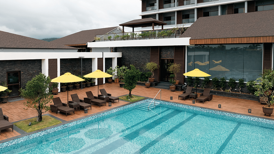An overhead view of the swimming pool and sun loungers at Cloud9 Sarovar Premiere, Palolem Goa, showcases a relaxing and inviting atmosphere