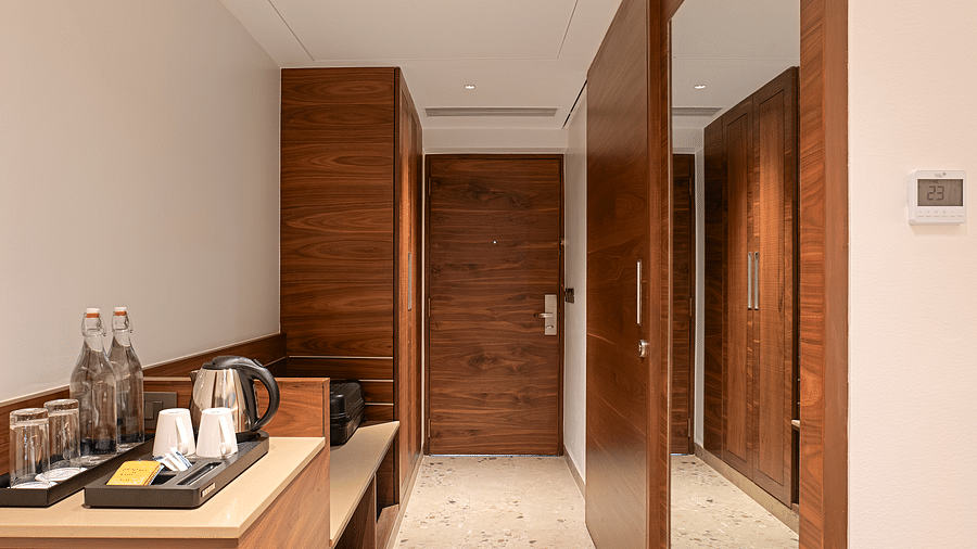 A floor-length mirror opposite the minibar and tea/coffee maker section in one of the rooms at Cloud9 Sarovar Premiere, Palolem Goa, enhancing the room's spacious feel