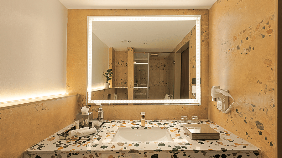 View of the vanity unit in one of the rooms at Cloud9 Sarovar Premiere, Palolem Goa, featuring a sleek design with ample space for toiletries and personal items