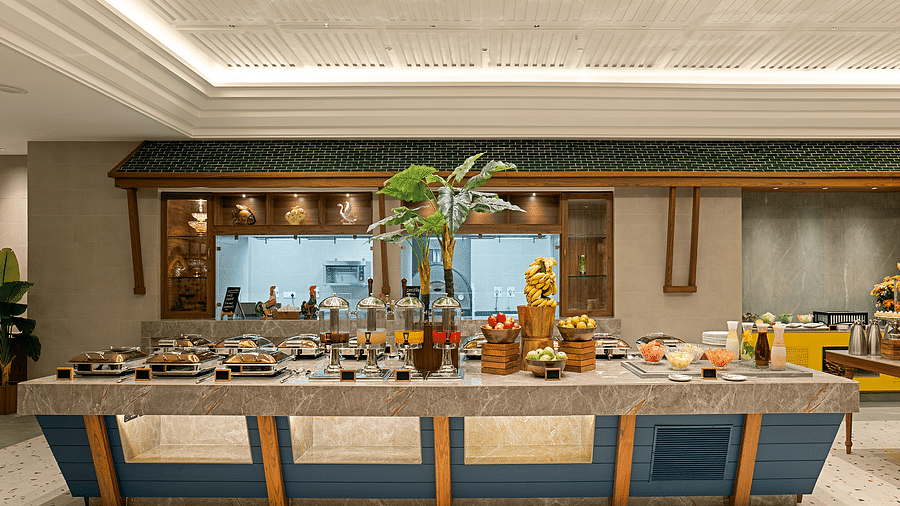 The central island in the dining area is thoughtfully arranged, with meals covered by silver lids on one side and fruits and vegetables on the other, divided by a plant in the centre at Cloud9 Sarovar Premiere, Palolem Goa