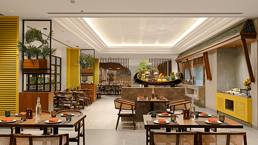 A spacious dining area with neatly arranged tables, chairs, and a well-set culinary layout awaits guests at Cloud9 Sarovar Premiere, Palolem Goa