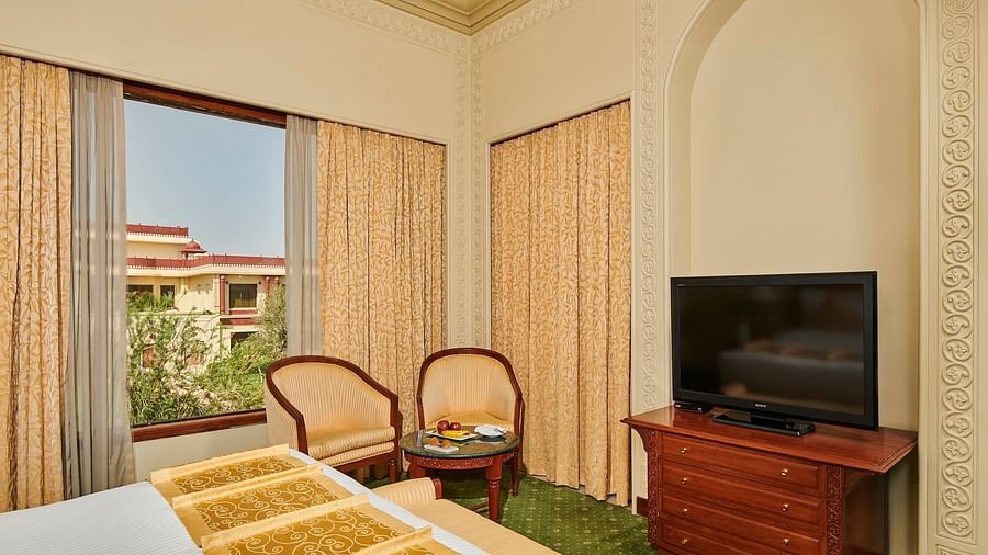corner view of luxury suite with showcasing a television on a cabinet  - The Ummed Jodhpur, Palace Resort and Spa