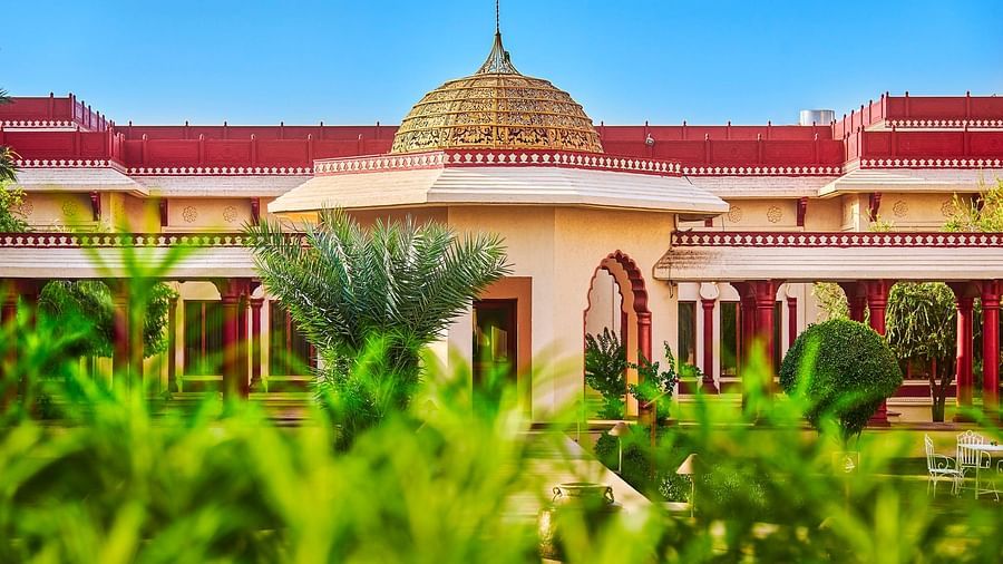 a closer view of our hotel surrounded by green trees - The Ummed Jodhpur, Palace Resort and Spa