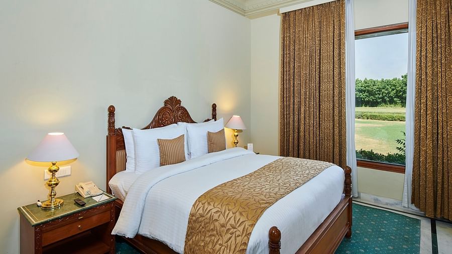 a suite bedroom with cosy bed and superior interior featuring a window next to the bed - The Ummed Jodhpur, Palace Resort and Spa