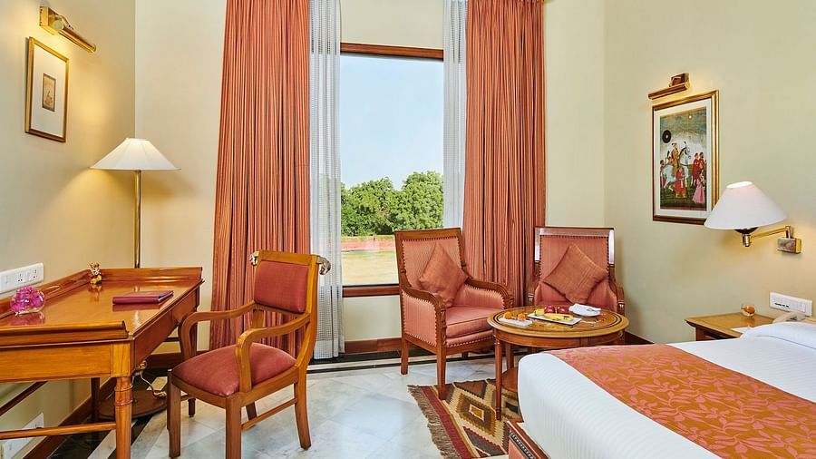 deluxe room with red curtains and workdesk corner view - The Ummed Jodhpur, Palace Resort and Spa