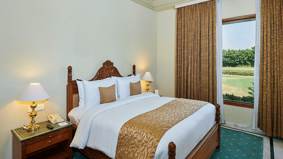 Royal Suite Master Bedroom with blue floor and white linens - The Ummed Jodhpur, Palace Resort and Spa