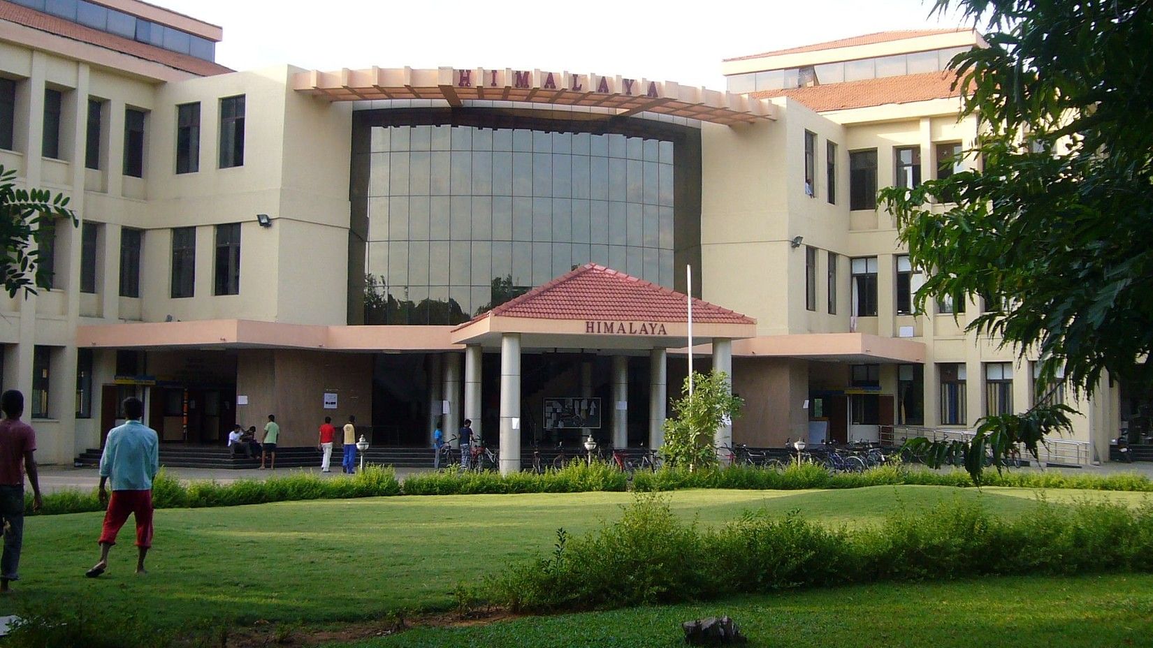A College building and a manicured lawn in front of it