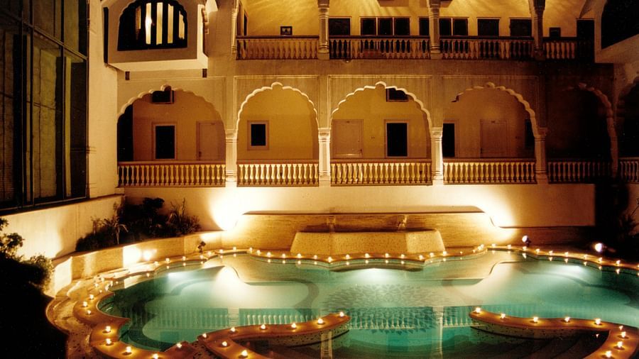 Swimming pool in the night with Mandawa Haveli, Jaipur in the background