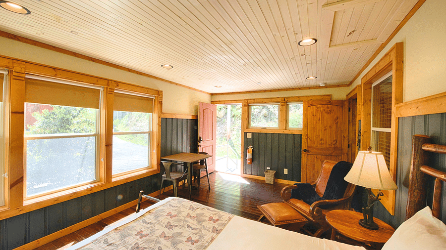 corner view of the room featuring the entry door opening tot he exterior with bright natural light