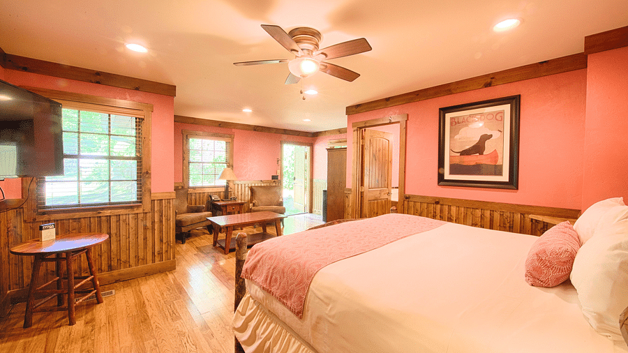 side view of a room with a double bed featuring a photo frame hanging on the wall - Historic Tapoco Lodge