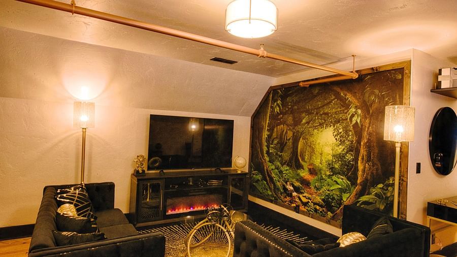 a welcoming image of the common seating area along with a flat screen television and an electric fireplace - Historic Tapoco Lodge