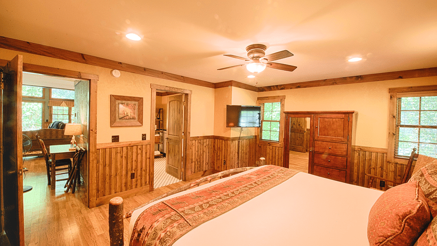 corner view of a bedroom with rustic wooden interiors overlooking a plush double bed - Historic Tapoco Lodge