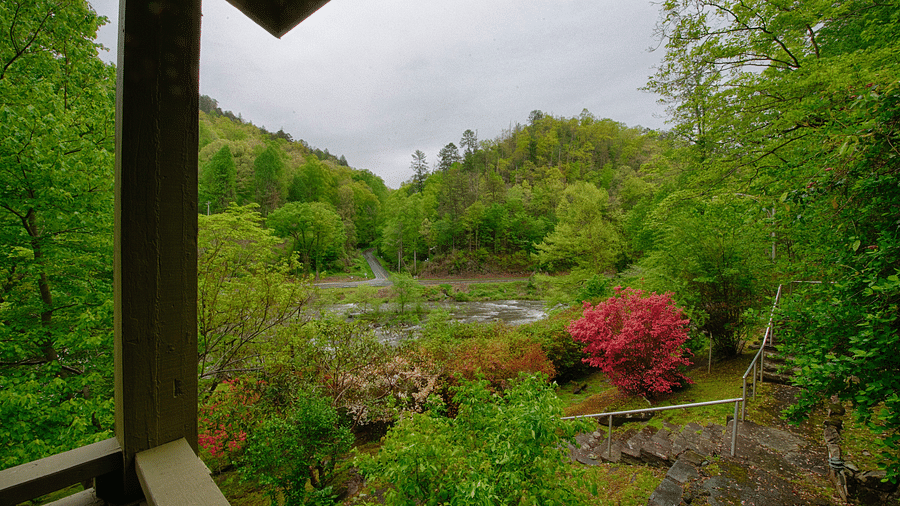 a beautiful scenery of the forest with an enchanting lake in the middle of it from the porch - Historic Tapoco Lodge