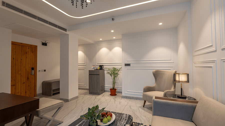 an image of a living space with a lamp and a chair at Mastiff Select Mandavya Dharamkot, McLeodganj