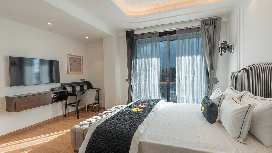 an image of a bedroom with a balcony mountain view at Mastiff Select Mandavya Dharamkot, McLeodganj