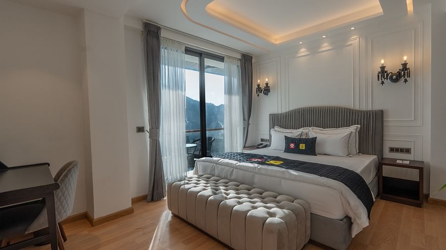 an image of a suite with antique light holder illuminating yellow lights at Mastiff Select Mandavya Dharamkot, McLeodganj