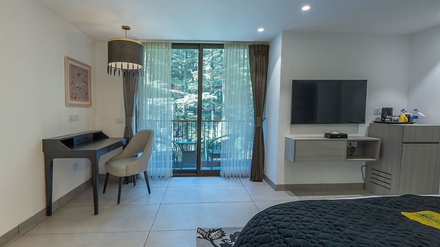 an image of a interior view of a premier room with a working table and a chair at Mastiff Select Mandavya Dharamkot, McLeodganj