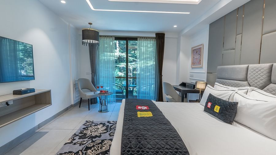 an image of a premier room with a bed and a television at Mastiff Select Mandavya Dharamkot, McLeodganj