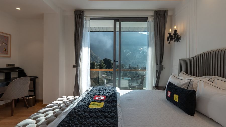 an image of a suite directing to balcony at Mastiff Select Mandavya Dharamkot, McLeodganj