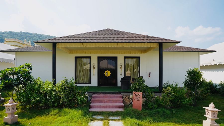 Facade of an accommodation with plants and grass surrounding it at Rajasthali Resort & Spa Jaipur.