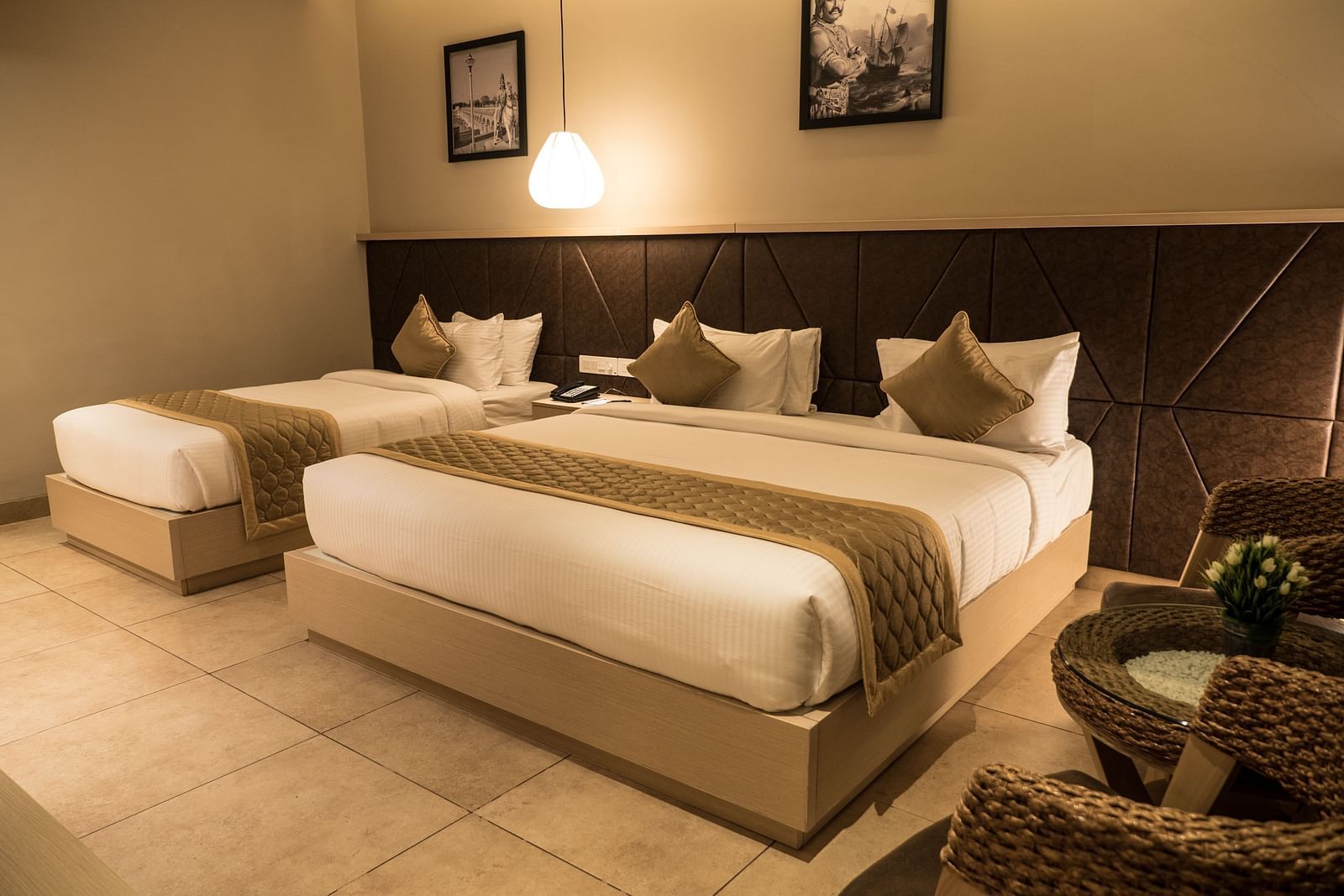 view of a king size bed and a single bed at Executive Tripple Room at Cholaa Dynasty, Kumbakonam