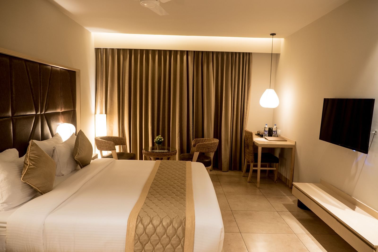 view of king size bed and TV of Premium Room at Cholaa Dynasty, Kumbakonam