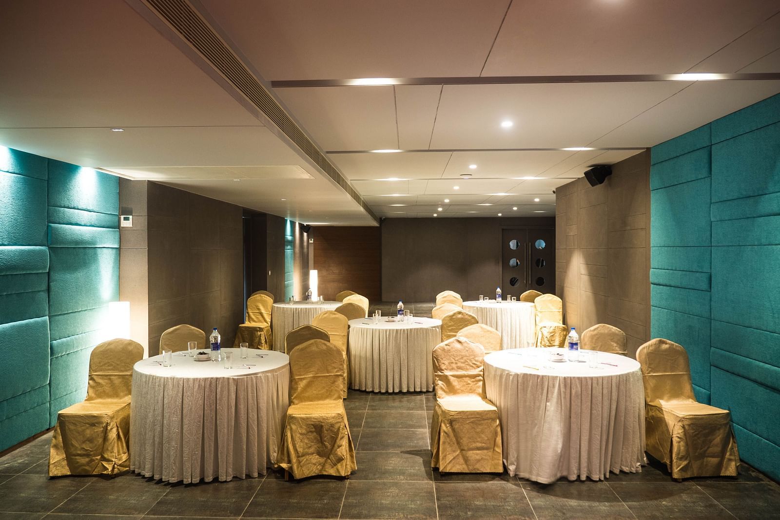 event halls with yellow chairs and white table at Cholaa Dynasty, Kumbakonam