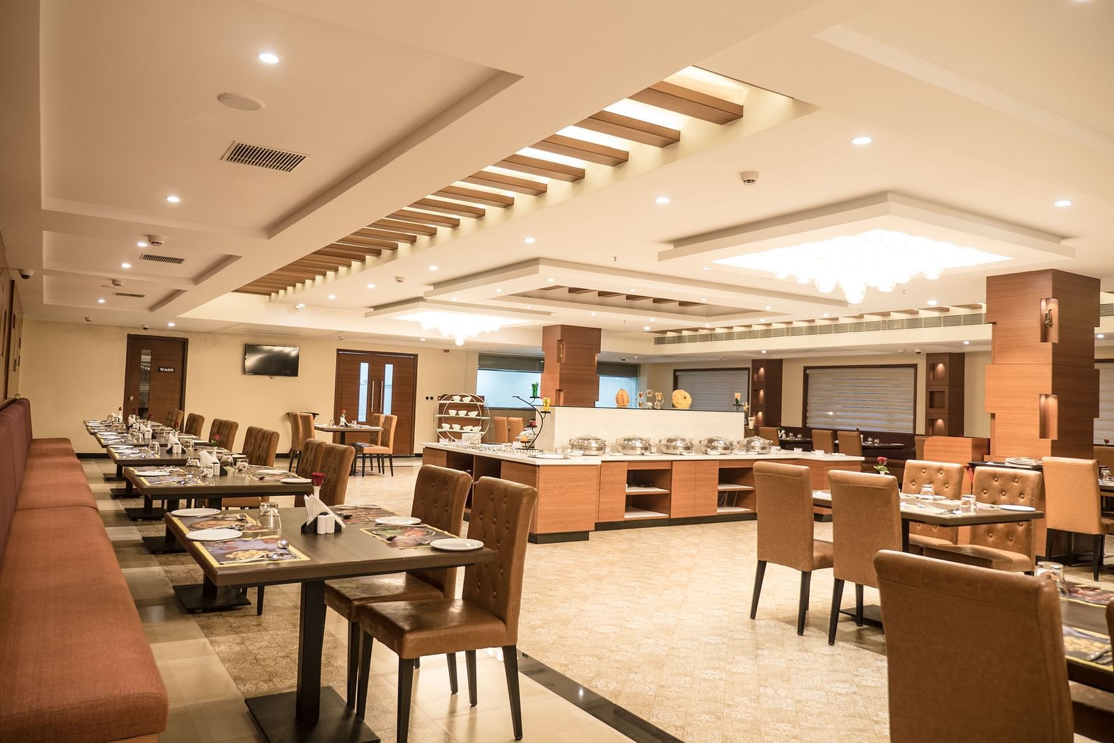 dining of a restaurant with warm lights of MM Legacy, Kanchipuram
