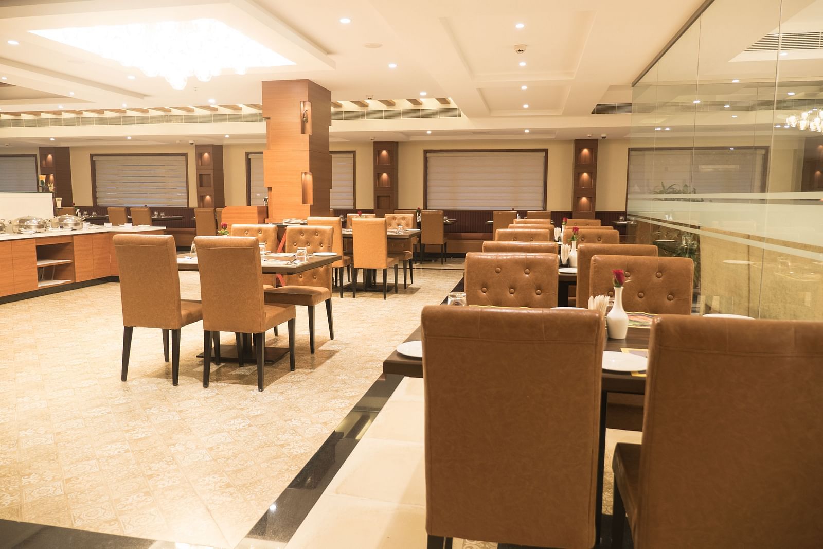 dining of a restaurant with warm lights of MM Legacy, Kanchipuram