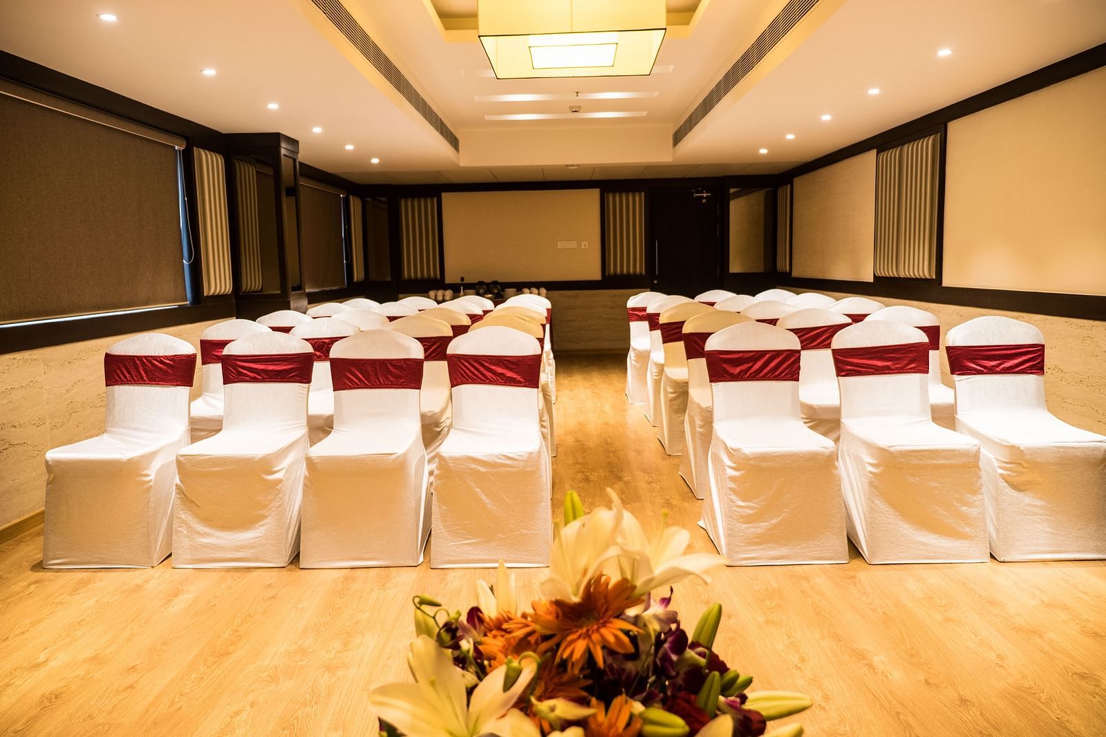 event hall with white satin chair and red ribbon of MM Legacy, Kanchipuram