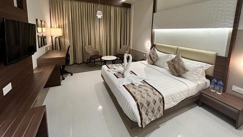A full view of Deluxe Double Room with a plush double bed and bedding
