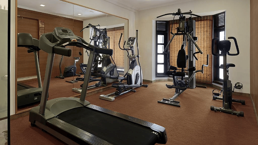 Fitness equipments including a treadmill and weight machine in a gym room at Ramada by Wyndham Mussoorie Mall Road.