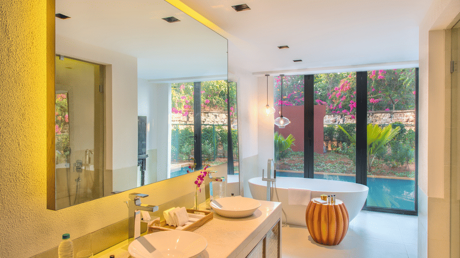 Bathroom with white ceramics, clean interiors and a large mirror