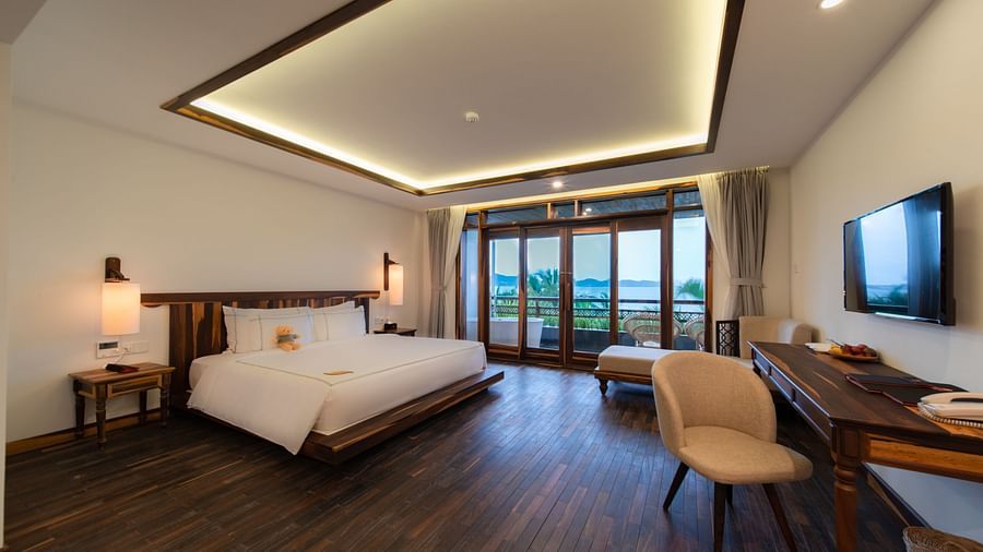 An image of a well furnished bedroom with a balcony - Alibu Resort Nha Thrang
