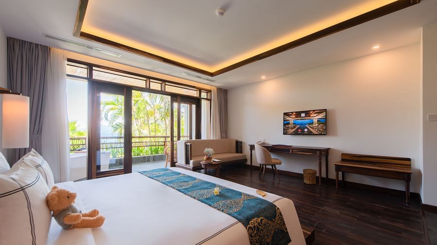 An image of a bed which has a teddy bear on it - Alibu Resort Nha Thrang