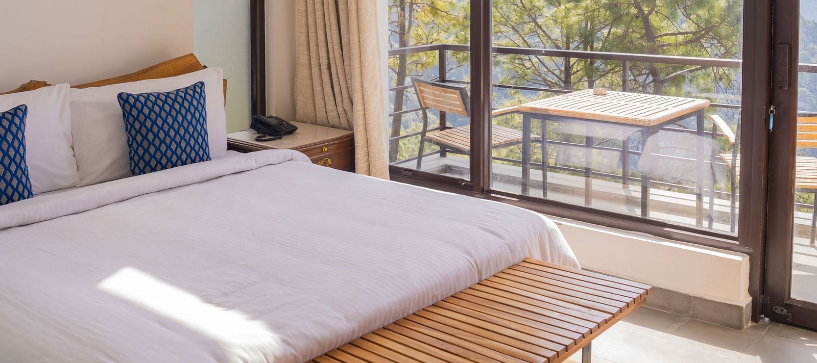 A bedroom featuring balcony at BluSalzz Escapade Resort, Lansdowne