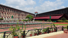 The exterior facade of cellular jail in Port Blair with white clouds on blue sky in the background.
