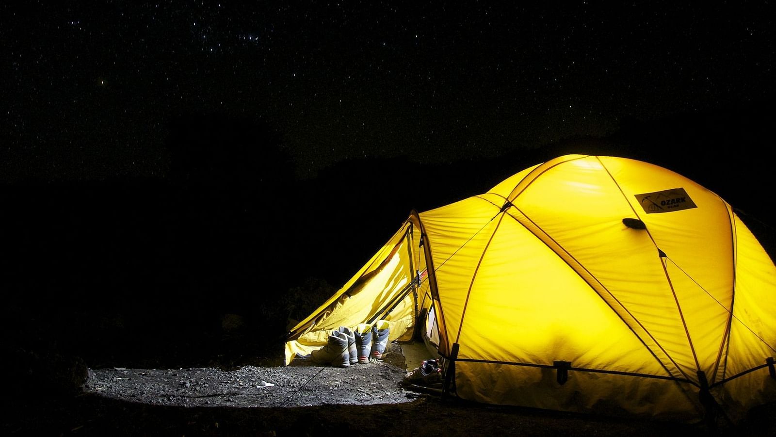 an image of Yellow tent lit from the inside at night