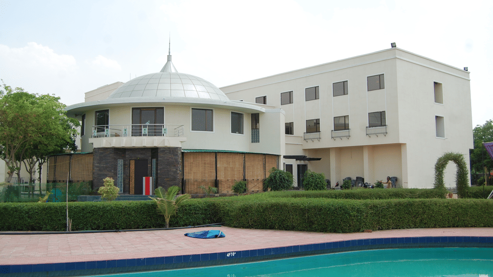 Grand facade of The Palm Resort, a luxury resort in Bhilwara