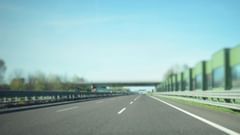 An overview of a highway with no cars in view and covering on the right side.