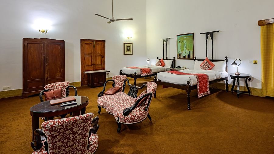 An overview of the Maharaja Narinder Singh room with twin double bed, sofas, coffee table - The Baradari palace